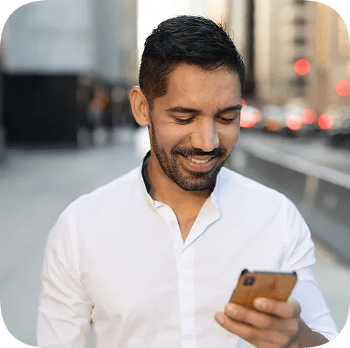 Man looking at phone for the religious organisation page